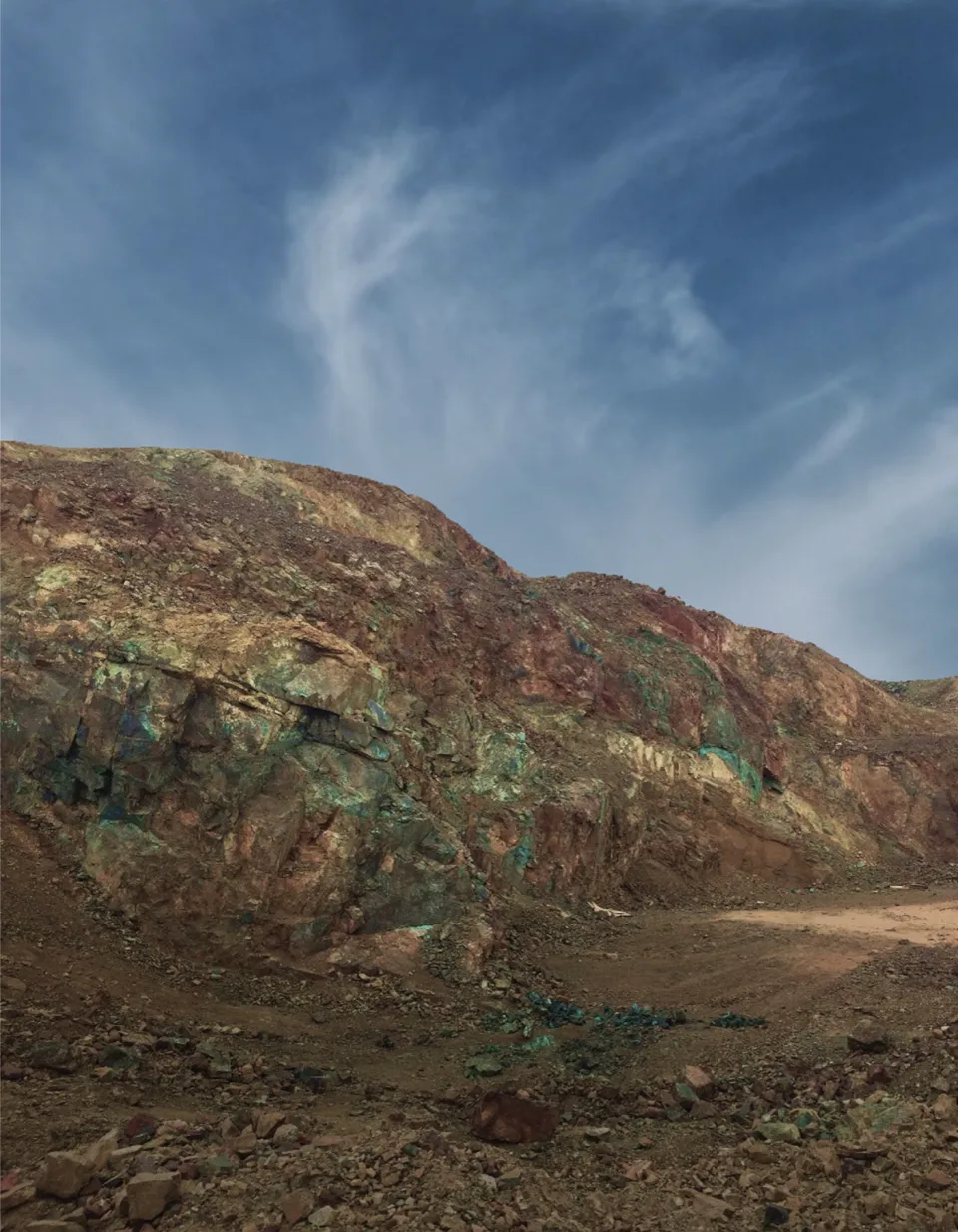 Copper-stained rock face at the Palo Negro and Hornitos project